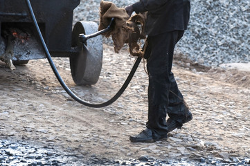 A man is spraying the bitumen