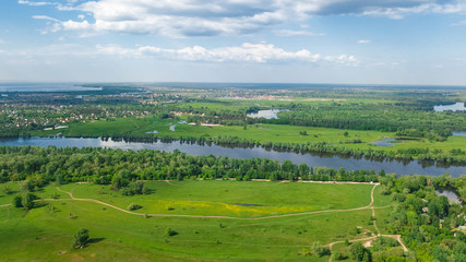 Aerial top view of Kyiv cityscape, Dnieper and Dniester river, green island from above, Kiev city skyline and nature parks in spring, Ukraine
