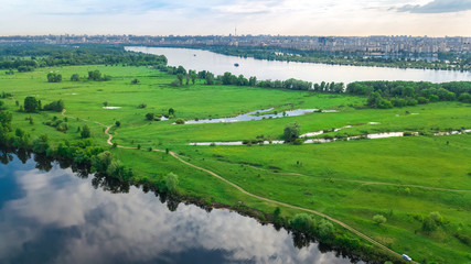 Obraz premium Aerial top view of Kyiv cityscape, Dnieper and Dniester river, green island from above, Kiev city skyline and nature parks in spring, Ukraine 