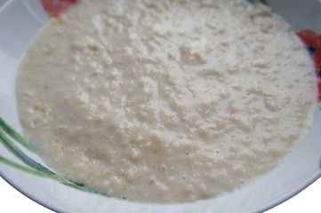 Porridge or oats dishes breakfast on white plate