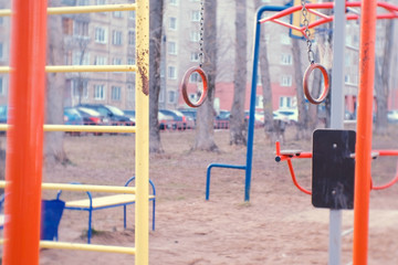 Fototapeta na wymiar Gymnastic rings in the courtyard of the town house on the Playground.
