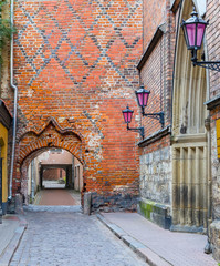 Morning in medieval district in old Riga. The city is capital of Latvia  and offers for tourists unique architectural Gothic ensembles and rare ancient buildings