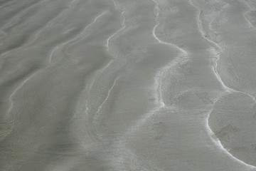 beach sand closeup with light footprints for backgrounds