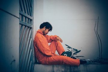 Portrait of asian handsome man in Prison uniforms,He has a lot Mustache and messy hair,Thailand...