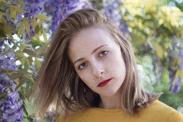 Portrait of a young woman on a wisteria background