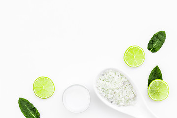 Organic citrus spa set for skin care. Lemon or lime moisturising cream and spa salt on white background top view copy space