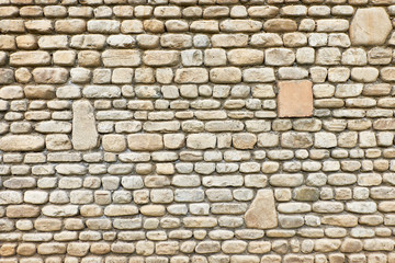 Texture of old brown stone wall for background built linearly and regularly.