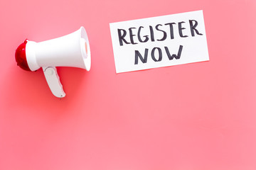 Register now hand lettering icon near megaphone on pink background top view copy space