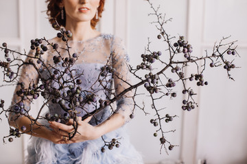 thorn branches in the hands of a girl