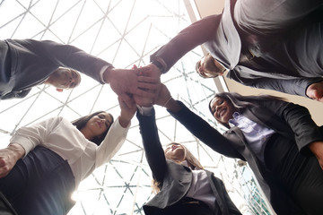 A group of business people from different ethnic backgrounds rejoices and celebrates their success...