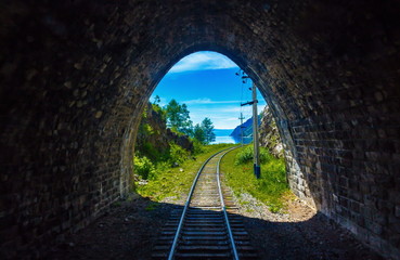 Light at the end of the tunnel on Circum-Baikal railway. Conceptual background representing hope,...