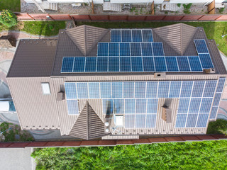 aerial view of house with solar roof. clean energy