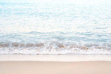 Tropical golden sea beach and soft wave with white foam on sand vacation in summer.