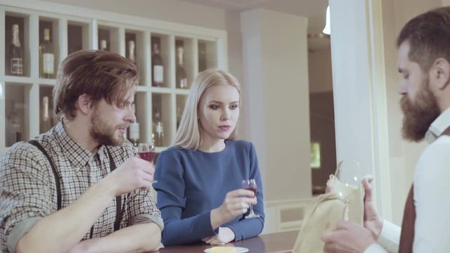 Beautiful couple in a restaurant. Cheerful couple in restaurant making an order. Romantic couple dating in pub