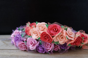 Beautiful floral wreaths on a wooden table on a black background