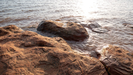 rocks in lake with writing on them