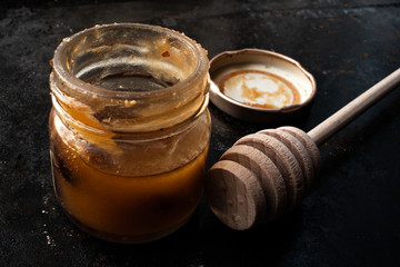 Honey in a smal jar with dark background
