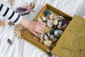 Little boy (4-5) with box full of treasures