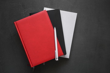 Office dark table. Mock up book blank black, red, white, leather cover for magazine, booklet,...