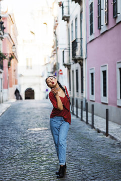 Portugal, Lisbon, Young woman blowing kiss in old town