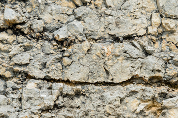 Textured stone background Rubble ballast in natural form in the rock wall
