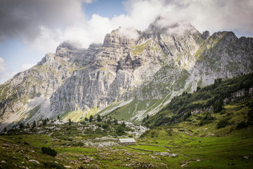 Idyllic alpine landscape of farmhouses, high mountains and unspoiled nature in Switzerland, Glarus