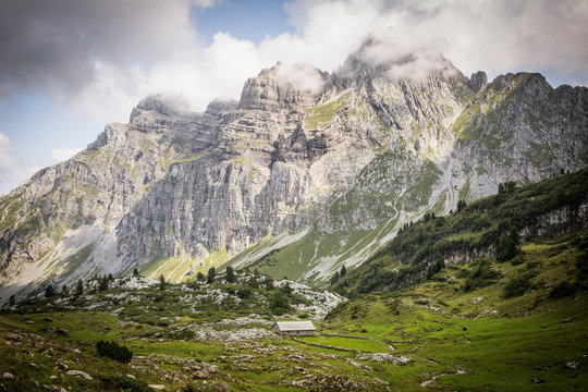 Idyllic alpine landscape of farmhouses, high mountains and unspoiled nature in Switzerland, Glarus