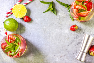 fresh lemonade with strawberries , lime and mint on a wooden background