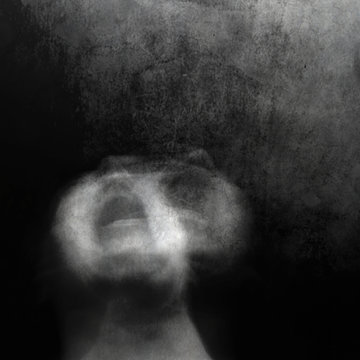 Scream of horror. Screaming woman face. Shot with long exposure.