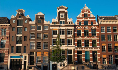 Typical old houses of Amsterdam under blue sky.