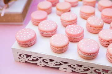 Pink macaroon on a white table horizontal, top view.Candy Bar buffet with macaroons at restaurant