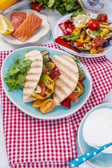 Mexican tacos with grilled vegetables and salmon. Healthy food for lunch. Fast food. Copy space.