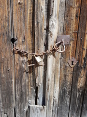  Rusty padlock on wooden gate