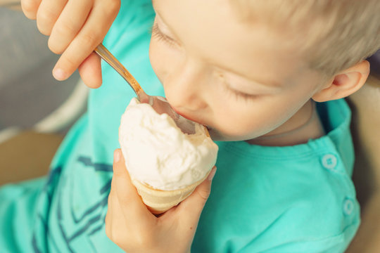 boy eating ice cream. harm sweet for children