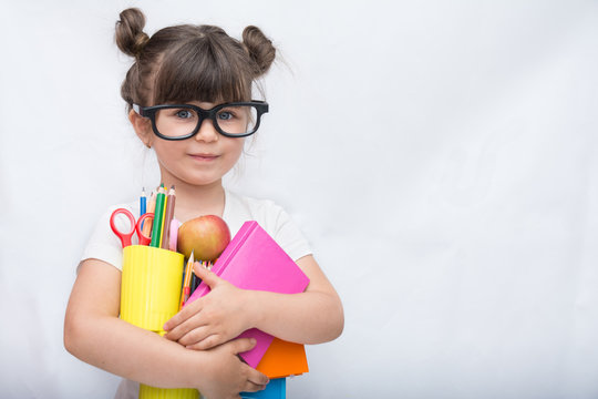 Kid Ready For School. Cute Clever Child In Eyeglasses Holding School Supplies: Pens, Notebooks, Scissors And Apple. Back To School Concept. Space For Text, Isolated On White.