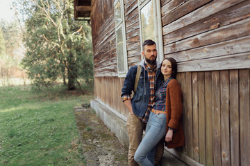 couple near old wooden house