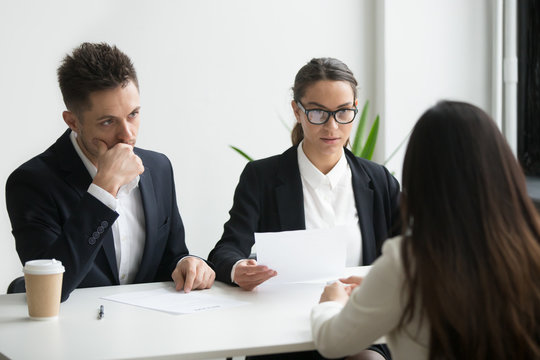 Concerned thoughtful hr managers listen to applicant, focused recruiters look doubtful uncertain about hiring incompetent candidate, bad first impression or failed job interview performance concept