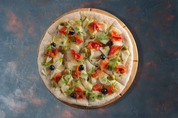 Top view of focaccia with cheese, tomato and olives