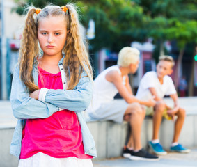 Fototapeta premium Upset girl after quarrel with playmates