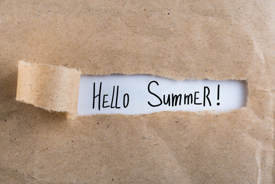 Hello Summer - text on torn brown envelope background