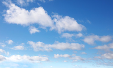 Soft fluffy white clouds blue sky background