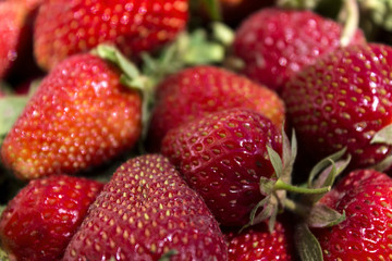 Ripe red strawberry on the market, background. Useful berries from the garden, growing at home