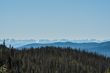 Landscape of snow capped mountains and trees in Colorado's Rocky Mountain National Park.
