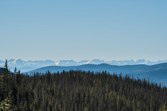 Landscape of snow capped mountains and trees in Colorado's Rocky Mountain National Park. © Kristina