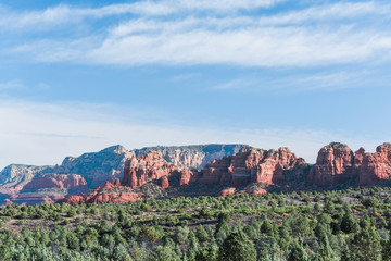 View of red rock formations and mountains in Sedona, Arizona.