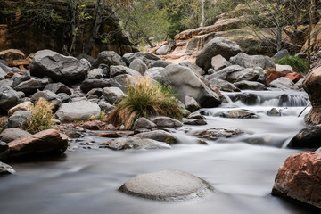 Long exposure of a river flowing through rocks at Sliding Rock State Park in Arizona.