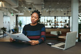 Young businesswoman reading document in the office