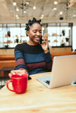 Smiling young businesswoman talking on smartphone 