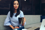 Young businesswoman holding coffee mug
