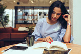 Businesswoman reading a book while sitting in office